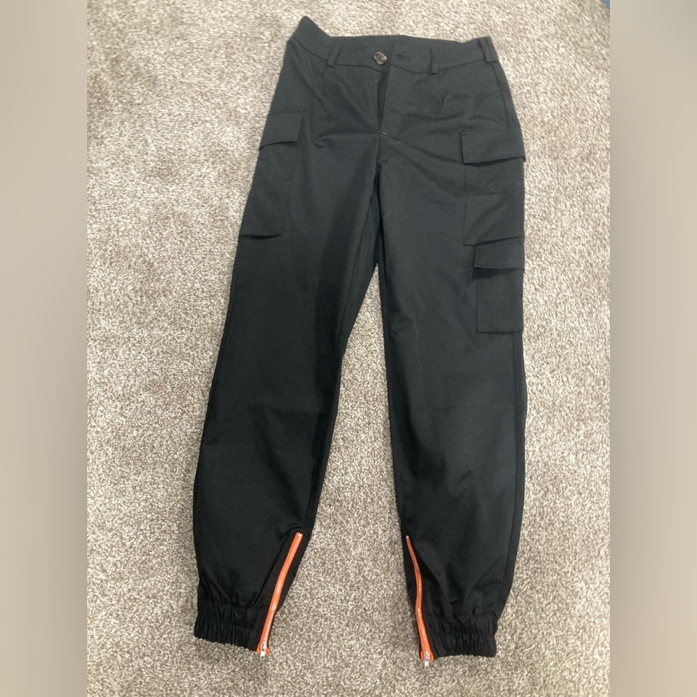 Cute medium size black work cargo pants with orange zipper at bottom.